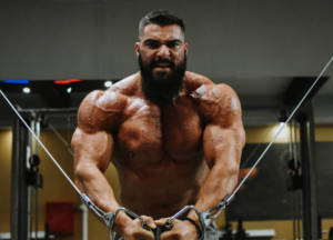 Muscular bodybuilder doing a cable workout, showcasing a dry and hard physique achieved with the best oral testosterone alternatives.