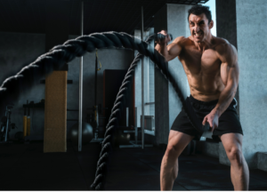 Athlete performing battle rope training during a high-intensity workout to improve strength, endurance, conditioning, and athletic performance. Ideal image for content about supplement stacks, pre-workouts, recovery supplements, sports nutrition, and fitness performance.